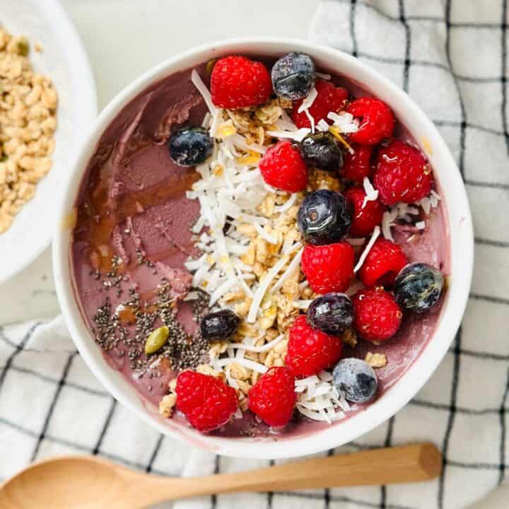 Scoops of acai smoothie bowl made with ninja creami ready to be enjoyed.