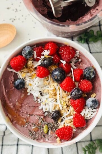 Scoops of acai smoothie bowl made with ninja creami ready to be enjoyed.