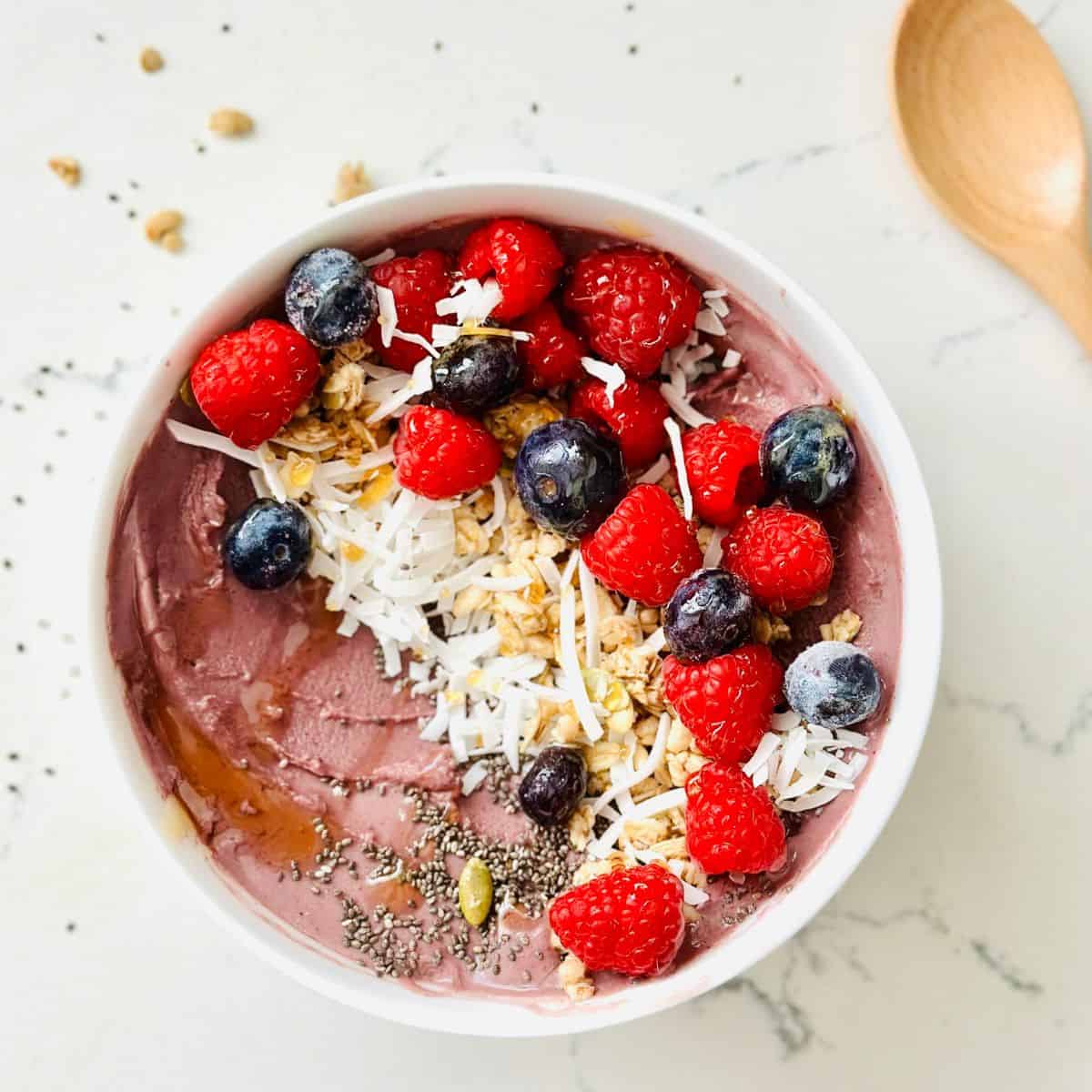 Scoops of acai smoothie bowl made with ninja creami ready to be enjoyed.