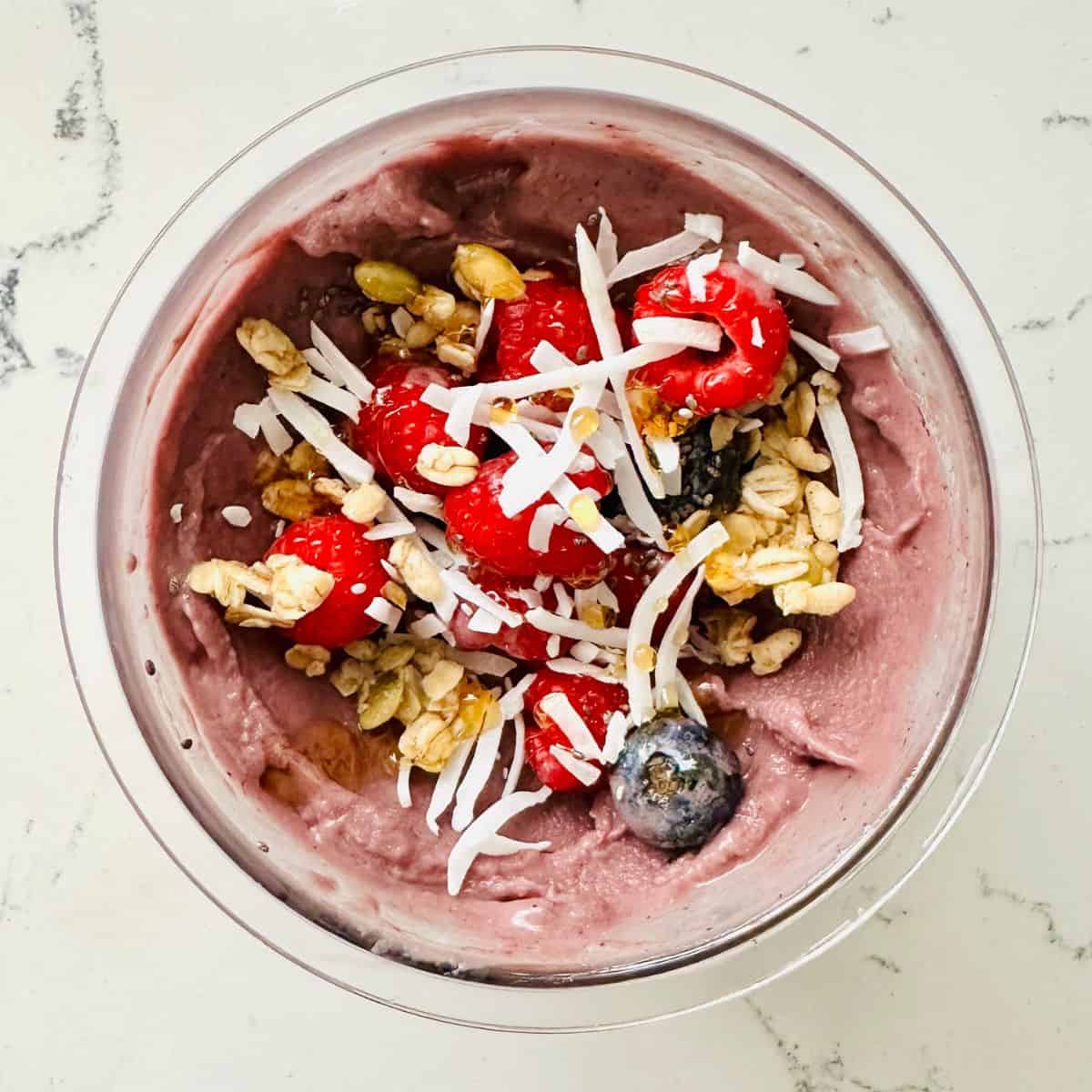 Frozen acai smoothie bowl made with ninja creami ready to be enjoyed.