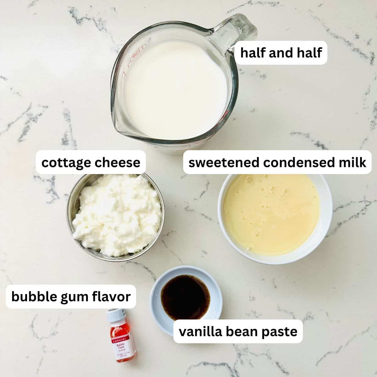 Ingredients for cotton candy ice cream arranged neatly on a marble table.