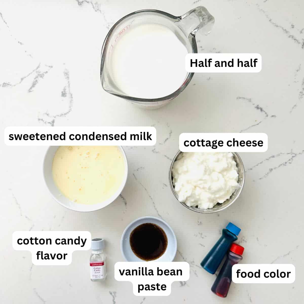 Ingredients for cotton candy swirl ice cream arranged neatly on a marble table.