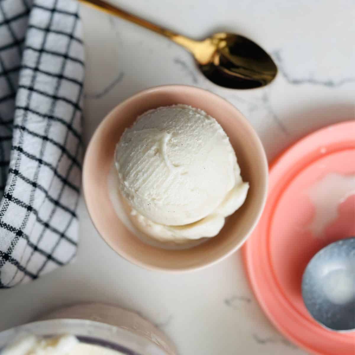 Scoops of high-protein vanilla ice cream in a bowl ready to be enjoyed.