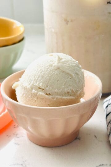 Scoops of high-protein vanilla ice cream in a bowl ready to be enjoyed.