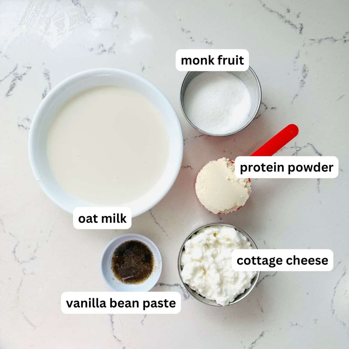 Ingredients for high-protein vanilla ice cream arranged neatly with labels.