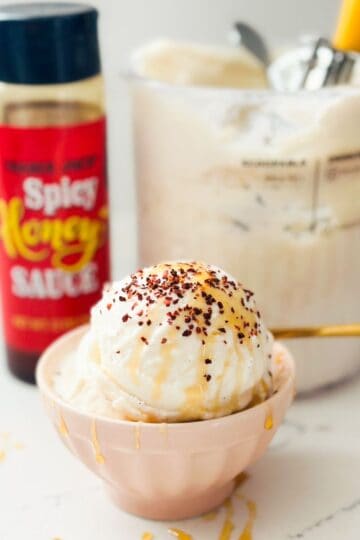 Scoops of hot honey ice cream with chili sprinkles and hot honey drizzles.