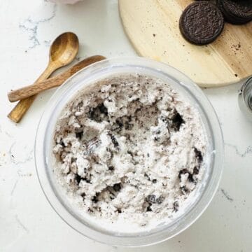 Mixture of Oreo Ice Cream in a Ninja Creami pint ready to be scooped.