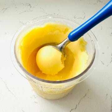 Scoop of dole whip ice cream made with Ninja creami ready to be enjoyed.