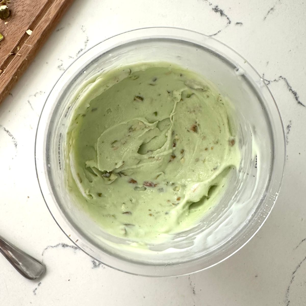 Mixture of pistachio ice cream with chopped pistachios ready to be enjoyed.