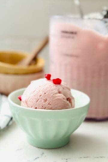 Scoop of rose raspberry ice cream in a bowl ready to be enjoyed.