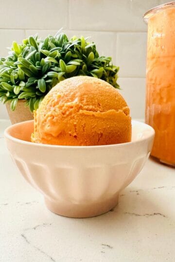 Scoops of thai tea ice cream in a bowl ready to be enjoyed.