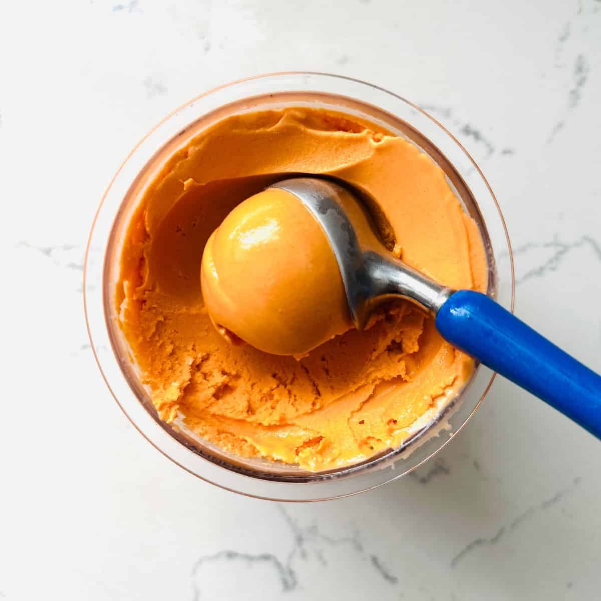 Scoop of thai tea ice cream in a bowl ready to be enjoyed.