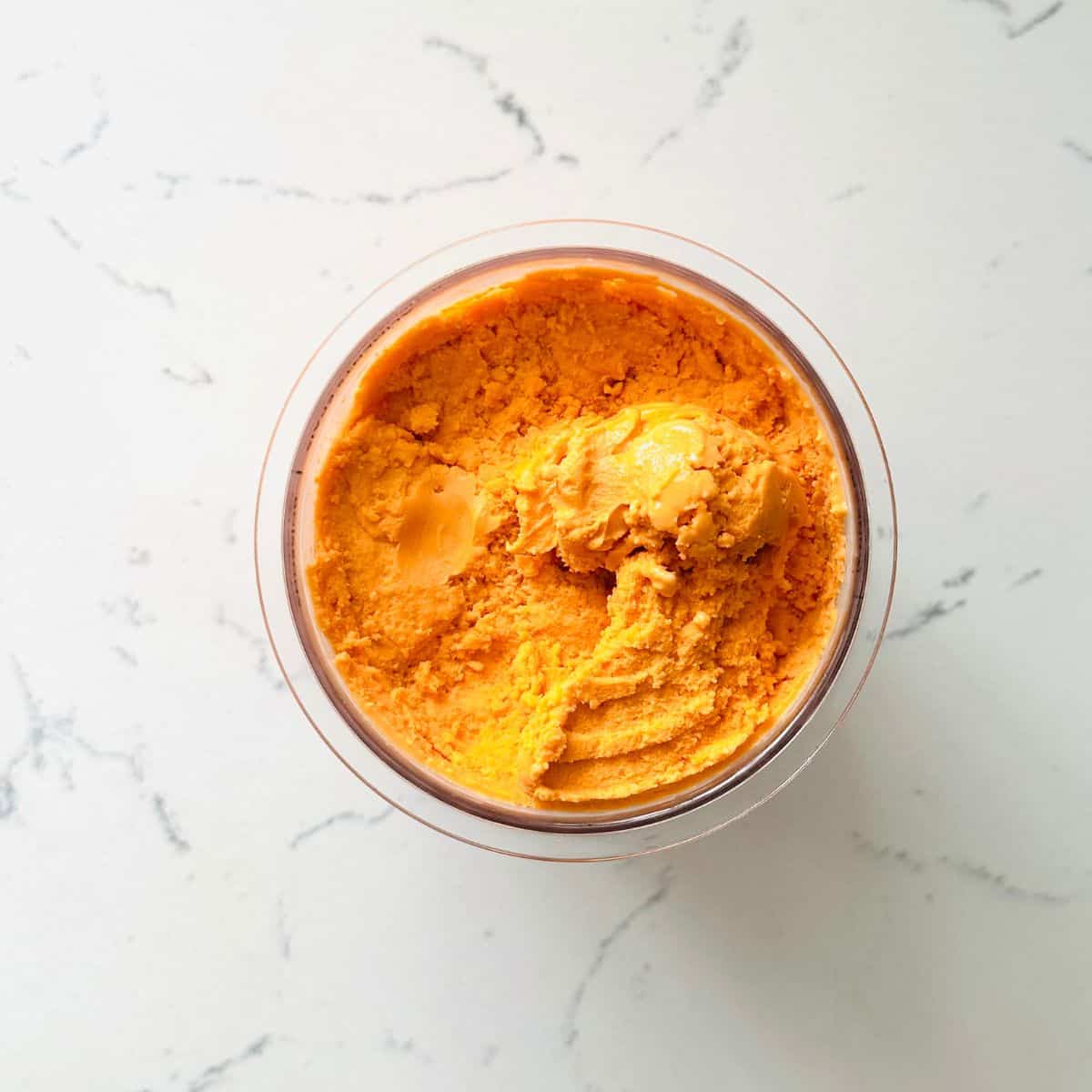 Freshly spun thai tea ice cream mixture ready for scooping.