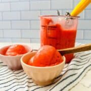 Scoop of creamy strawberry sorbet in a bowl.