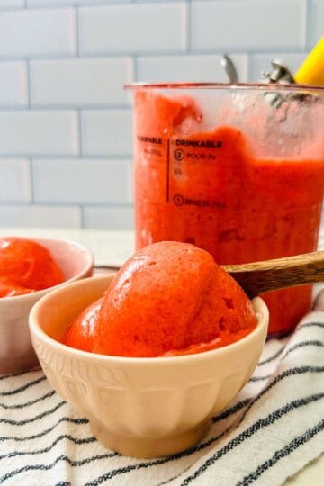 Scoop of creamy strawberry sorbet in a bowl.