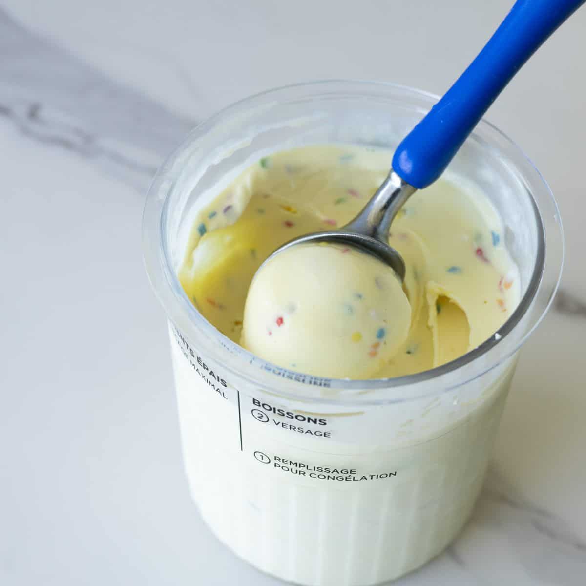 Scoop of homemade birthday cake ice cream made with the Ninja Creami, featuring a creamy texture, rich vanilla flavor.
