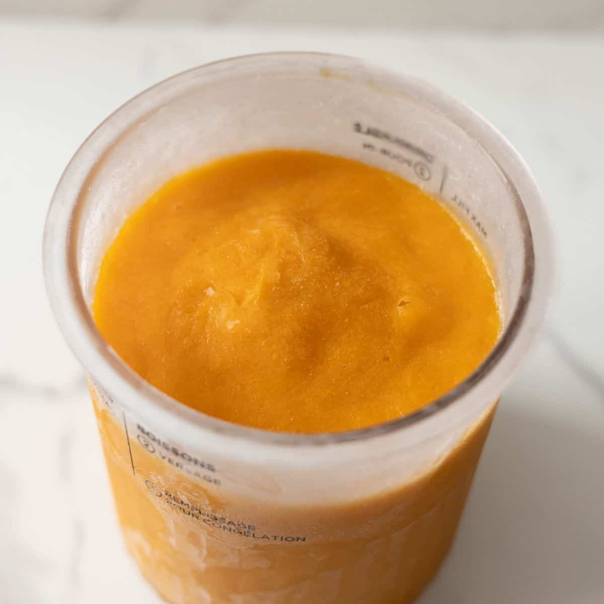 Frozen mango ice cream made with fresh mangoes, sweetened condensed milk, and half and half.