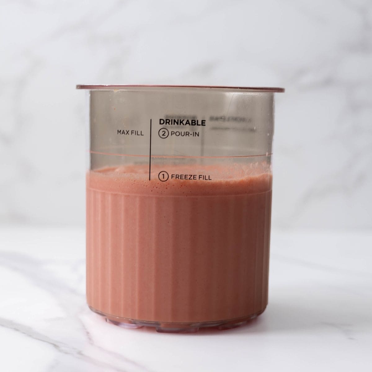 NInja Creami strawberry ice cream mixture ready to be frozen.