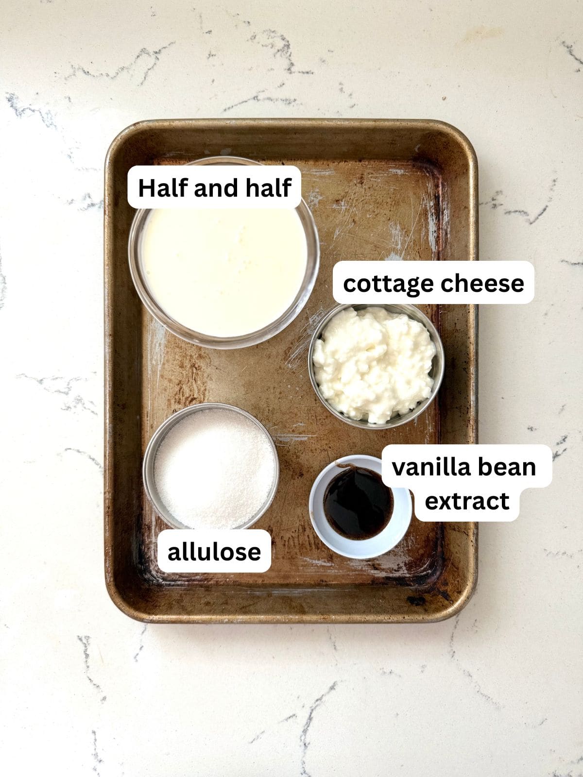Ingredients for making the creamiest sugar free vanilla bean ice cream made using Ninja Creami.