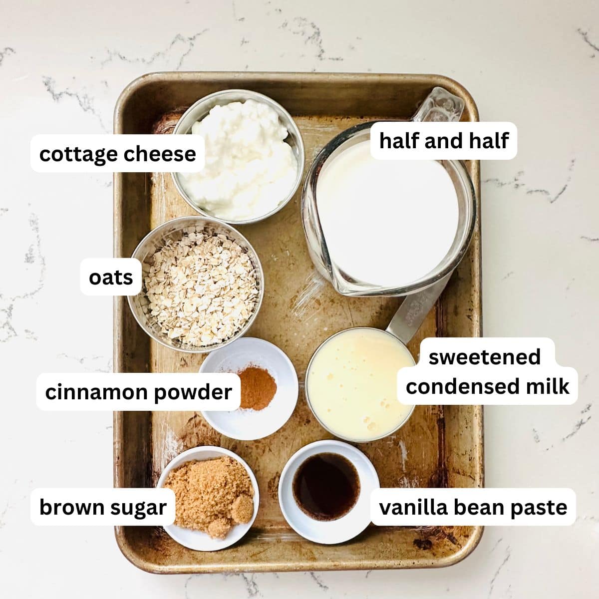 Ninja Creami Overnight Oats Ice Cream ingredients including oats, milk, Greek yogurt, and honey on a kitchen counter.