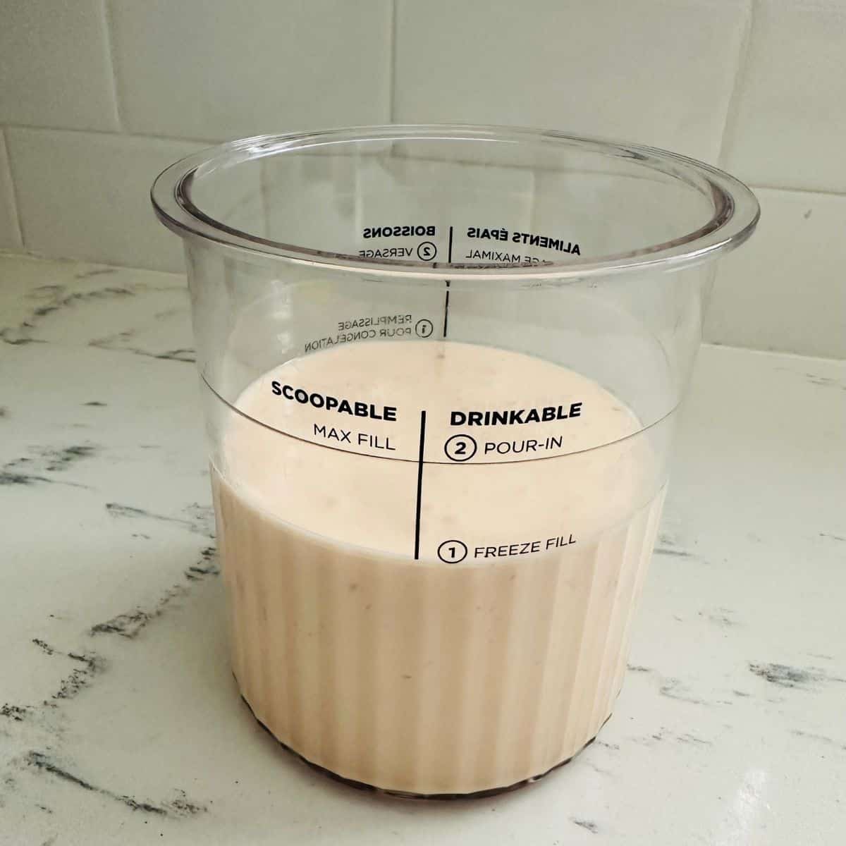 Blending red pepper jelly ice cream base in a blender until smooth and creamy for Ninja Creami.