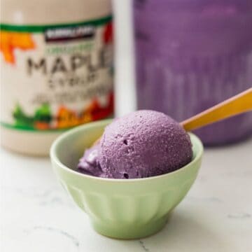 Scoop of homemade Maple Ube Latte Ice Cream in a bowl, showing its rich purple color and velvety texture.