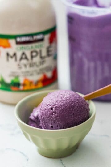 Scoop of homemade Maple Ube Latte Ice Cream in a bowl, showing its rich purple color and velvety texture.