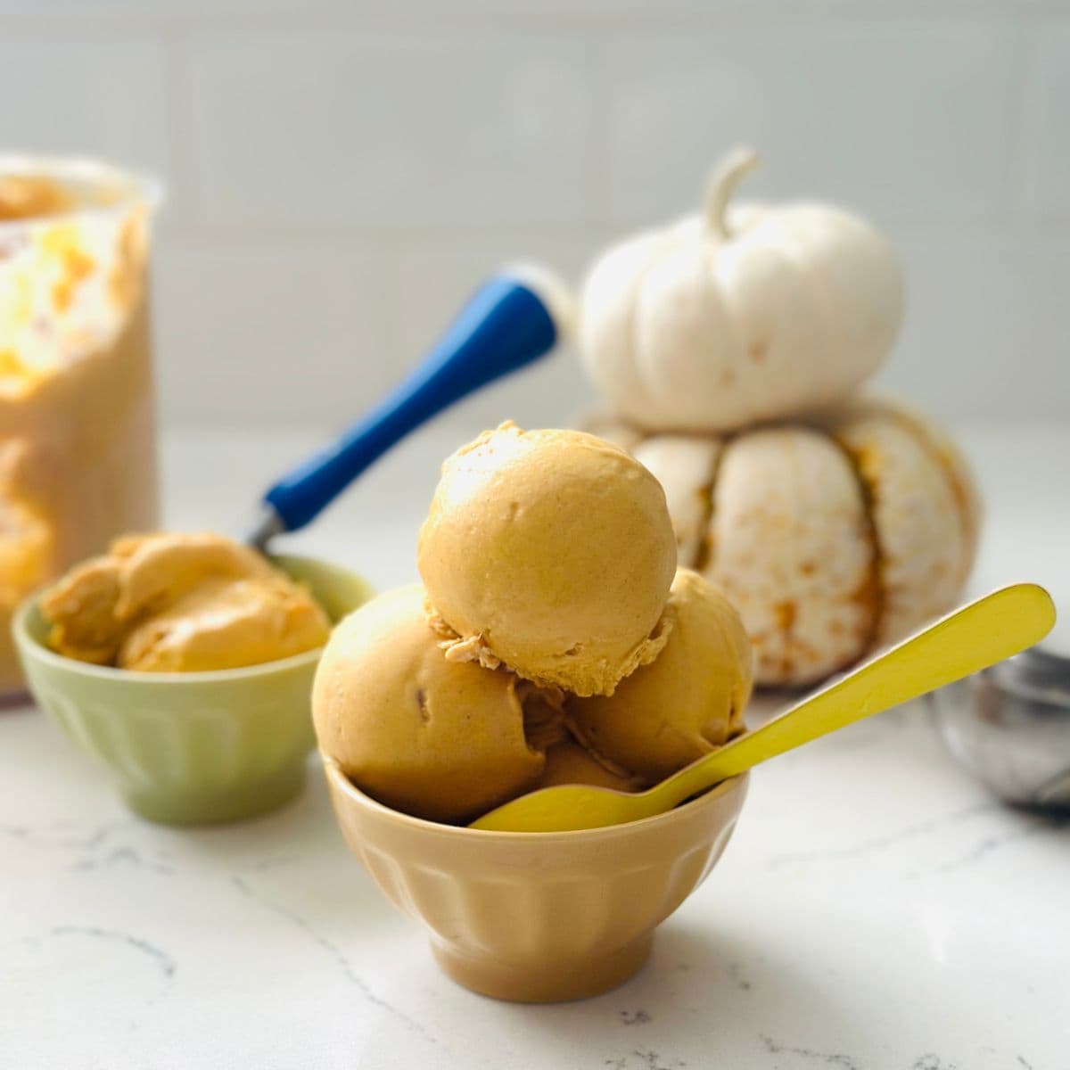 Scoops of Ninja Creami Pumpkin Cheesecake Ice Cream served in bowl with graham cracker topping.