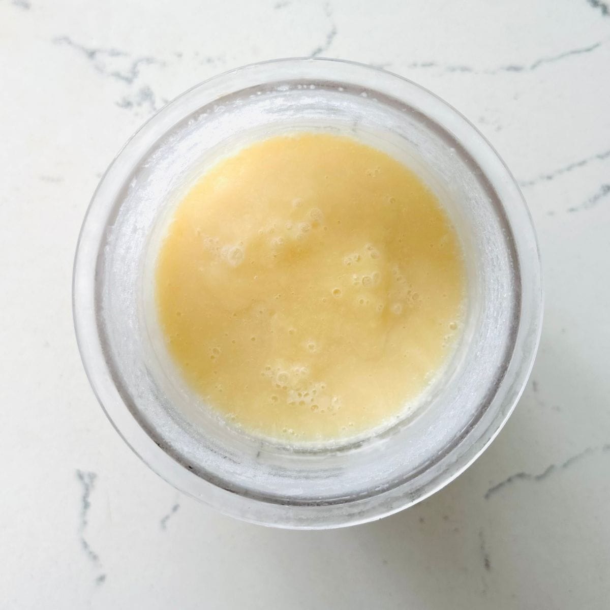 Frozen Ninja Creami Yakult ice cream base before processing.