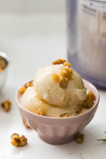 Scoop of Ninja Creami maple walnut ice cream with swirls of maple syrup and crushed walnuts.