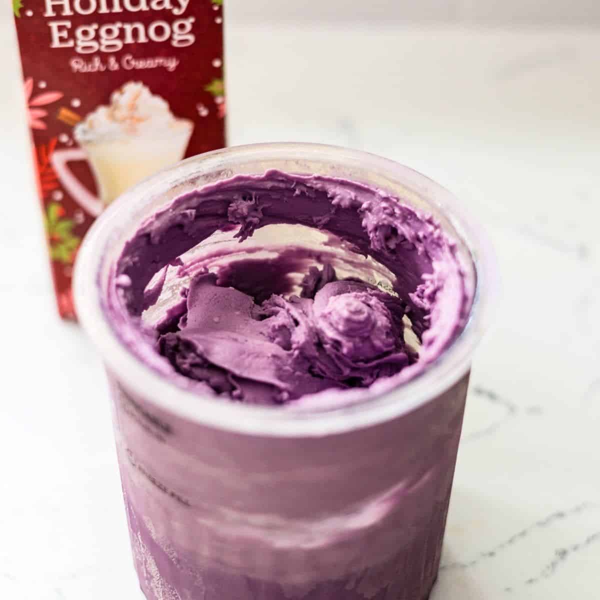 Ninja Creami ube eggnog ice cream with a thick, creamy purple texture in the pint container.