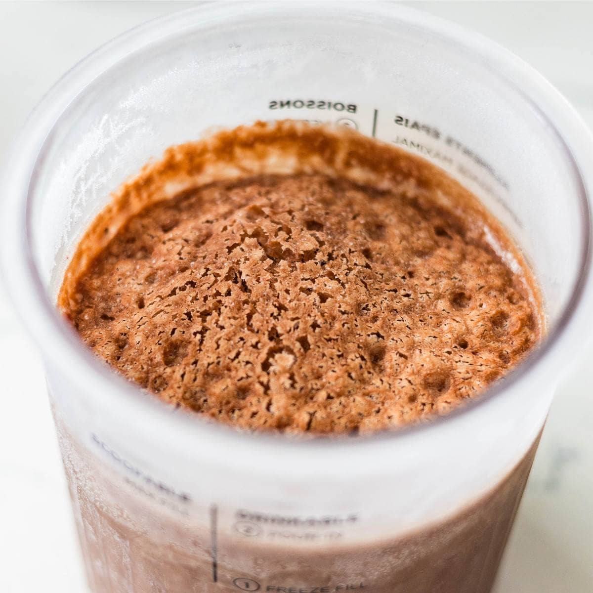 Frozen Ninja Creami chocolate strawberry ice cream in a pint container.
