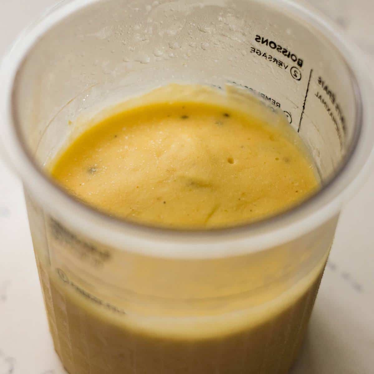 Frozen Ninja Creami mango cardamom ice cream in a pint container.