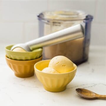 Scoop of mango cardamom ice cream in a bowl.