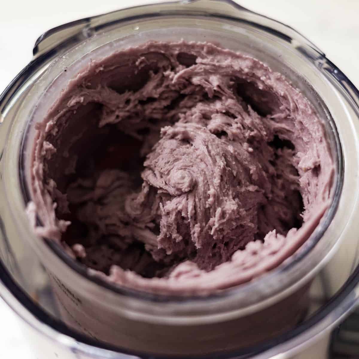 Top view of mixed berry Ninja Creami after spinning, showing a thick and fluffy texture inside the Deluxe pint.