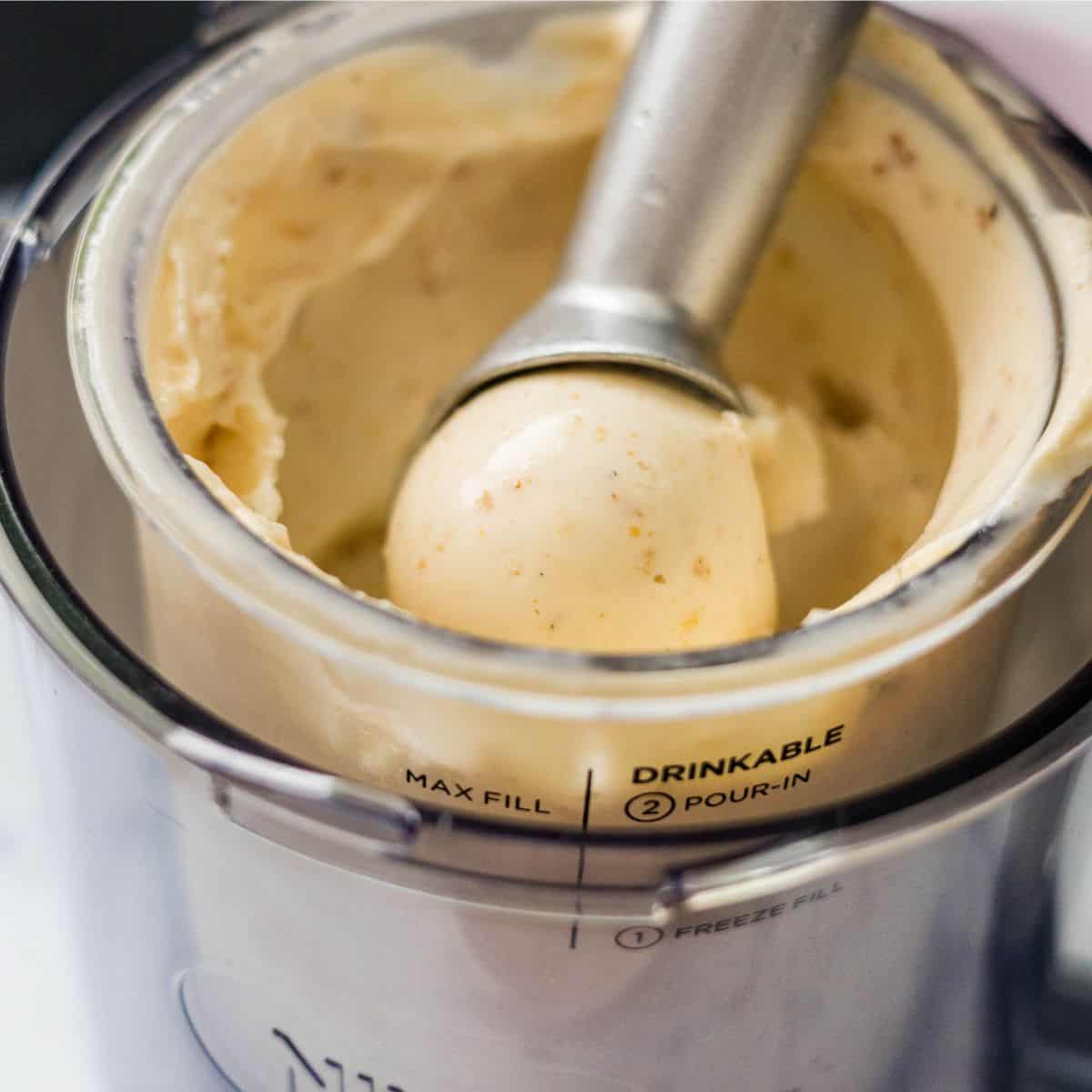 Creamy Ninja Creami Banana Ice Cream being scooped straight from the pint container.