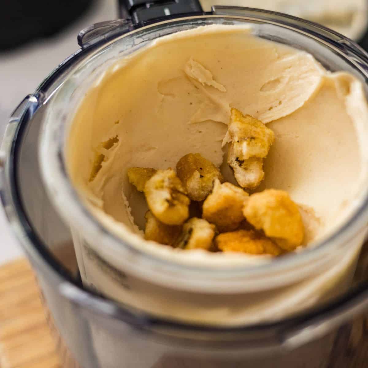 Crunchy banana chips added to Ninja Creami Banana Ice Cream before using the Mix-In setting.