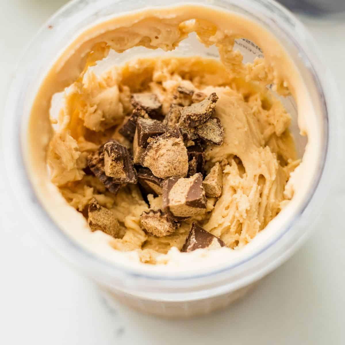 Chopped peanut butter cups added into the center of Ninja Creami peanut butter cup ice cream for the mix-in step