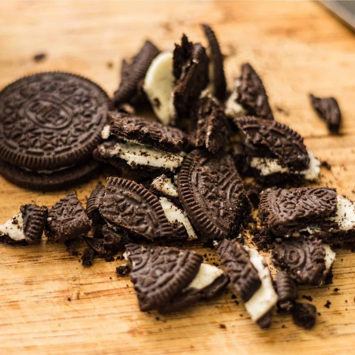 Chocolate sandwich cookies on a wooden board for making high protein cookies and cream ice cream.