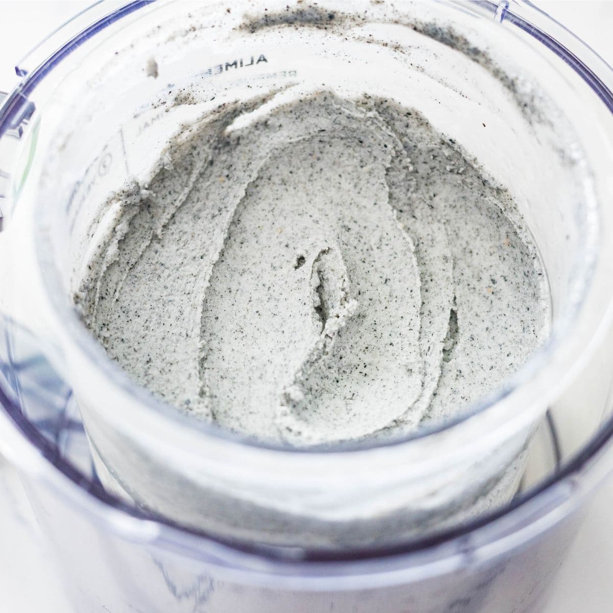 Creamy Ninja Creami black sesame ice cream after re-spinning until smooth in the pint container