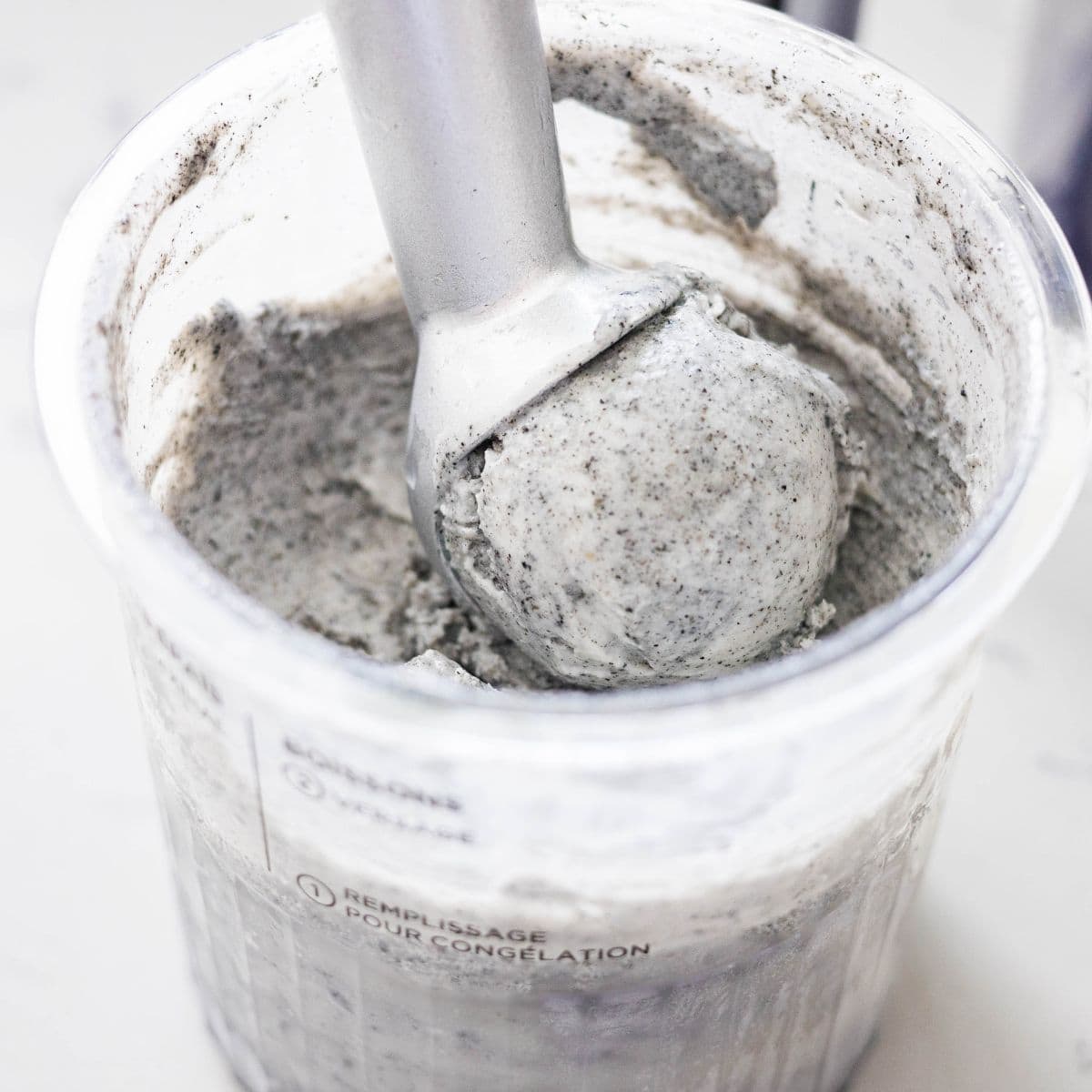 Scoop of creamy black sesame ice cream lifted from the Ninja Creami pint container