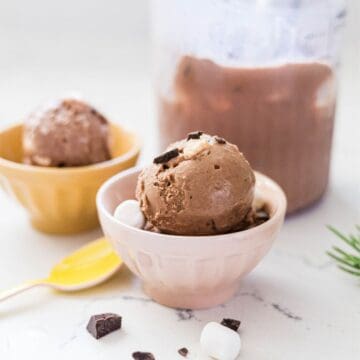 Homemade Ninja Creami rocky road ice cream served in a bowl with the pint in the background