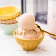 Homemade Ninja Creami root beer ice cream scooped into a yellow dessert bowl