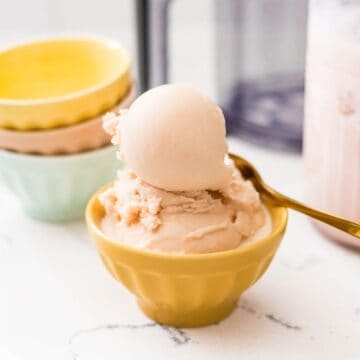 Homemade Ninja Creami root beer ice cream scooped into a yellow dessert bowl