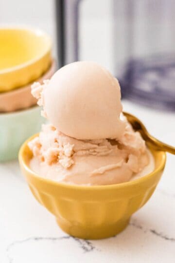 Homemade Ninja Creami root beer ice cream scooped into a yellow dessert bowl