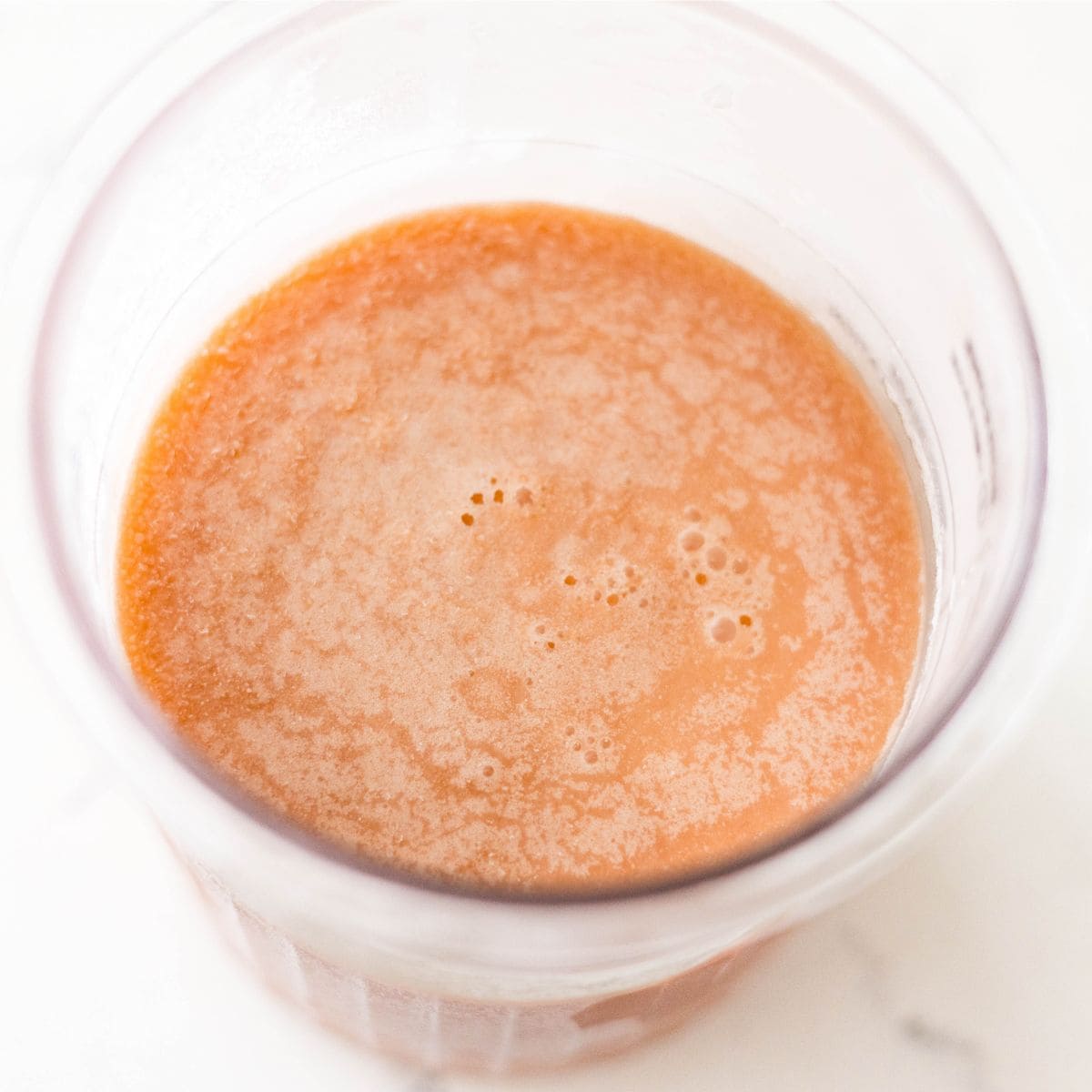 Frozen root beer ice cream base in a Ninja Creami pint before spinning