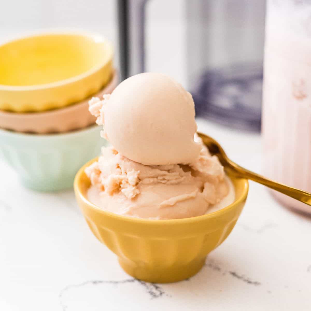 Homemade Ninja Creami root beer ice cream scooped into a yellow dessert bowl