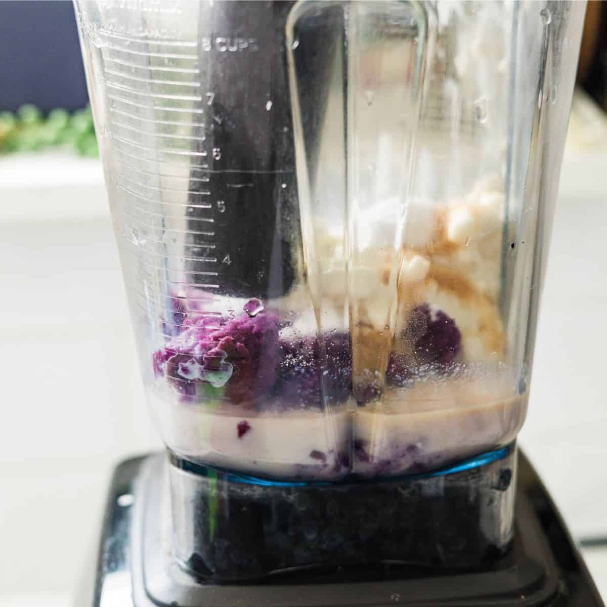 Purple sweet potato, cottage cheese, and protein shake in a blender for a high protein ice cream base