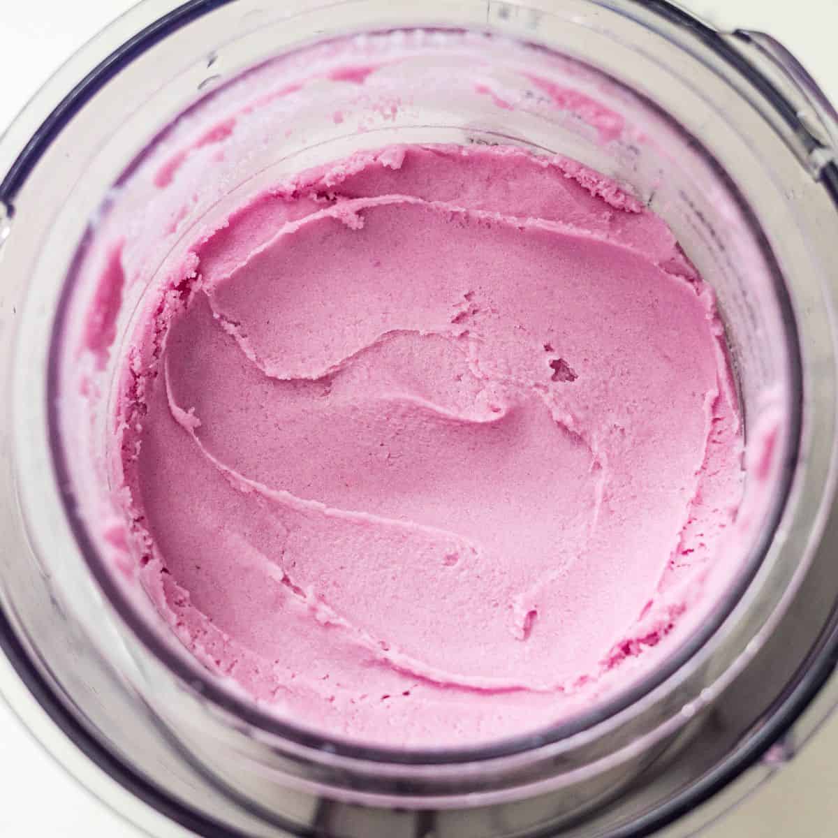 Smooth, creamy purple sweet potato protein ice cream in a Ninja Creami pint after a respin