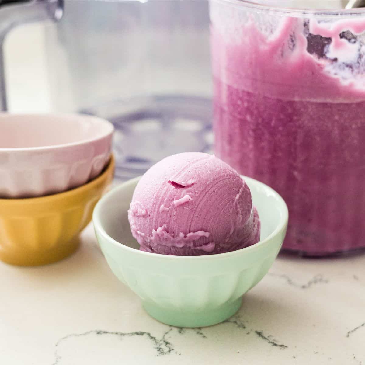 Single scoop of purple sweet potato protein ice cream in a mint green bowl, made with cottage cheese in a Ninja Creami